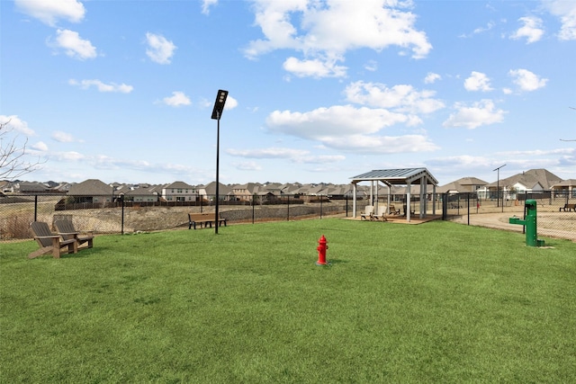 view of property's community with a gazebo and a yard