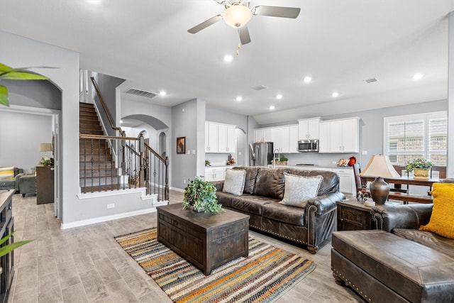 living room featuring light hardwood / wood-style floors and ceiling fan