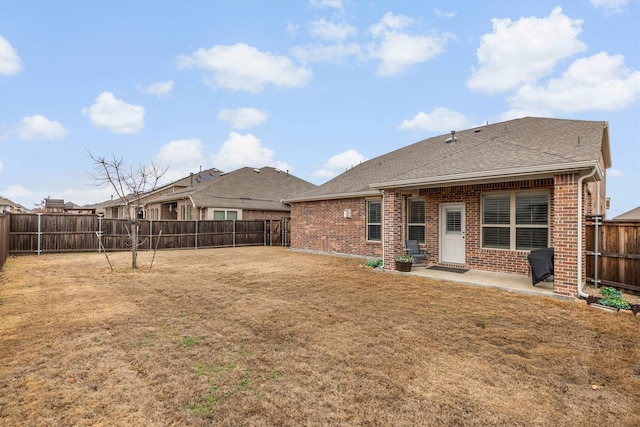 rear view of property with a patio area and a lawn