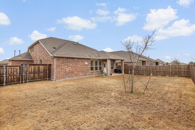 back of house featuring a lawn