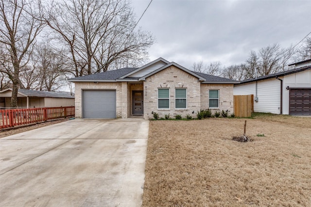 ranch-style home with a garage and a front lawn