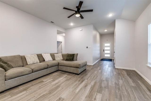 living room featuring ceiling fan, vaulted ceiling, and light hardwood / wood-style floors