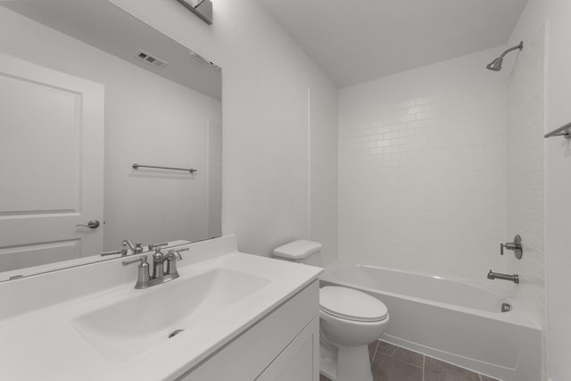 full bathroom featuring vanity, tile patterned floors, toilet, and tiled shower / bath