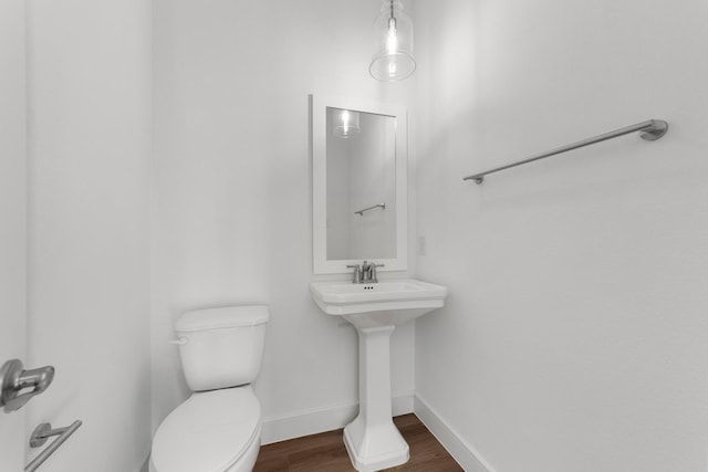 bathroom featuring sink, wood-type flooring, and toilet