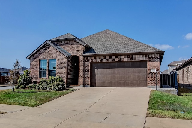 view of front of property featuring a garage and a front yard