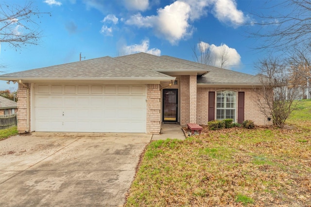 ranch-style house featuring a garage and a front yard