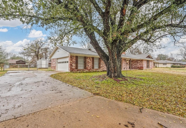 ranch-style house with a garage and a front lawn