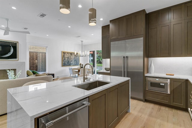 4529 Fairway, Highland Park, TX 75219 - kitchen featuring a sink, appliances with stainless steel finishes, open floor plan, light wood-style flooring, and recessed lighting