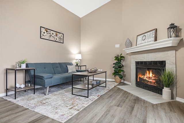4113 Esters Rd Unit 609, Irving, TX 75038 - living room with baseboards, high vaulted ceiling, wood finished floors, and a tiled fireplace