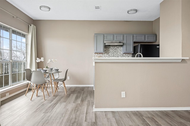 4113 Esters Rd Unit 609, Irving, TX 75038 - unfurnished dining area featuring baseboards, visible vents, and wood finished floors