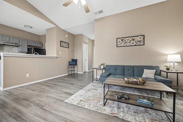 4113 Esters Rd Unit 609, Irving, TX 75038 - living room with a ceiling fan, wood finished floors, baseboards, and visible vents