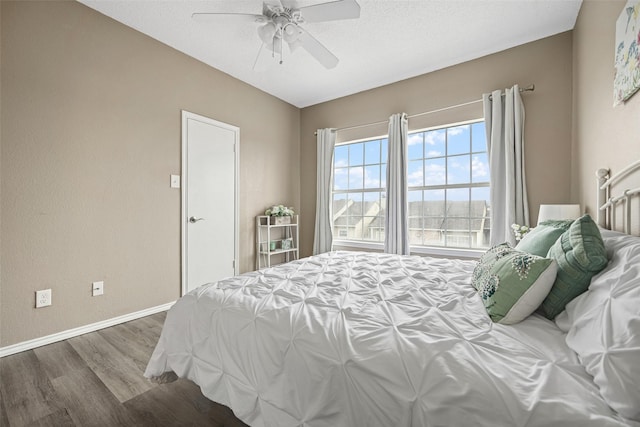 4113 Esters Rd Unit 609, Irving, TX 75038 - bedroom featuring baseboards, wood finished floors, ceiling fan, and a textured ceiling