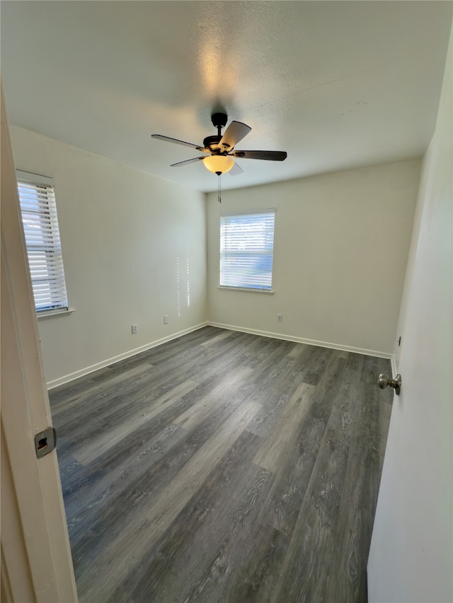 empty room featuring dark hardwood / wood-style floors and ceiling fan