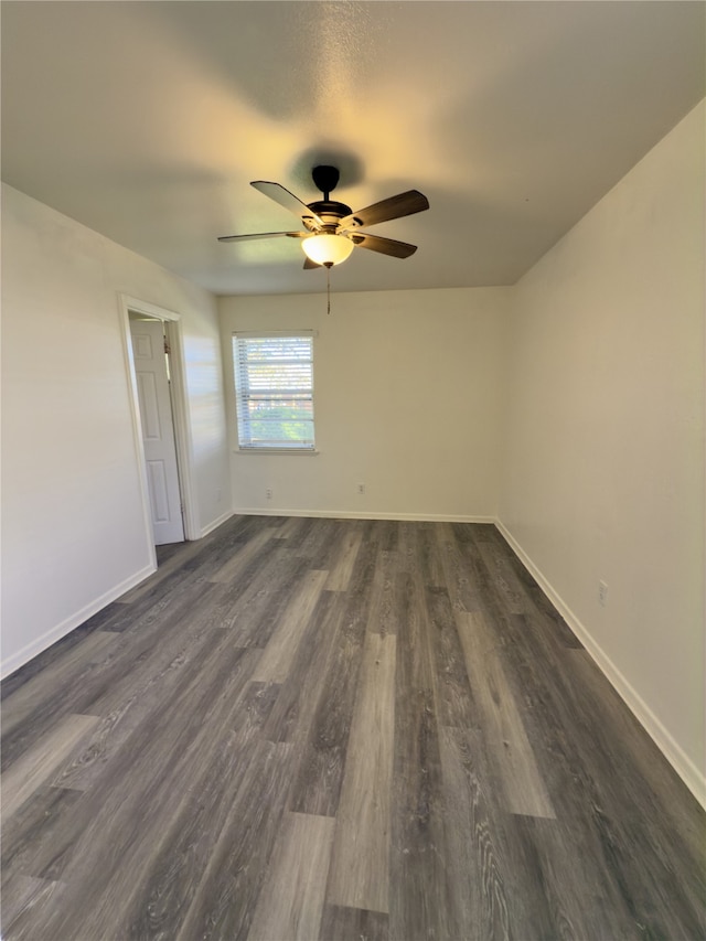 spare room featuring dark hardwood / wood-style floors and ceiling fan