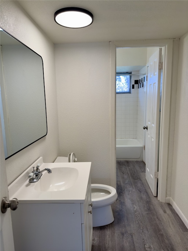 bathroom with vanity, toilet, and hardwood / wood-style floors