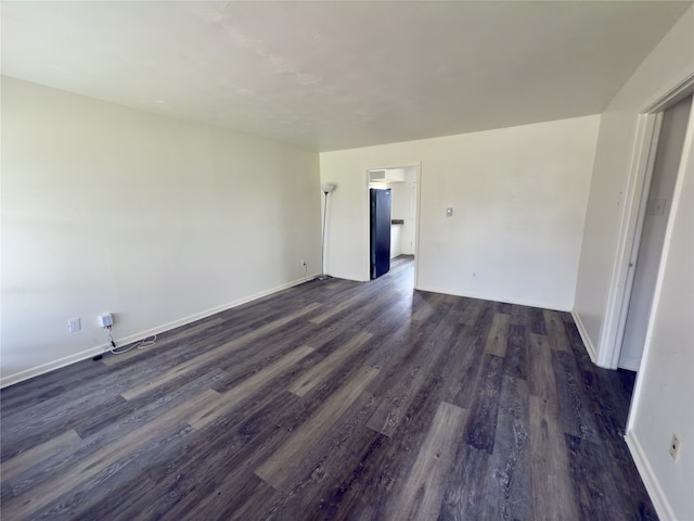 unfurnished room with dark hardwood / wood-style floors