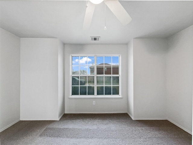 spare room featuring ceiling fan and carpet flooring