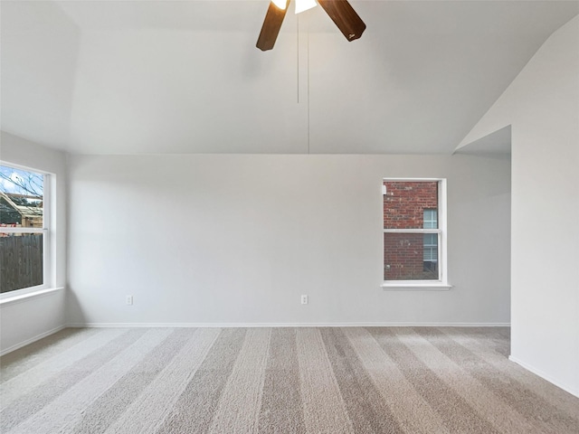 carpeted empty room with lofted ceiling and ceiling fan