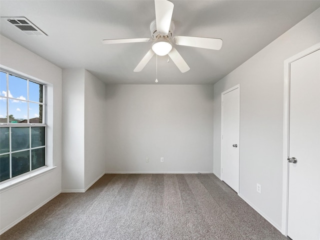 carpeted empty room featuring ceiling fan