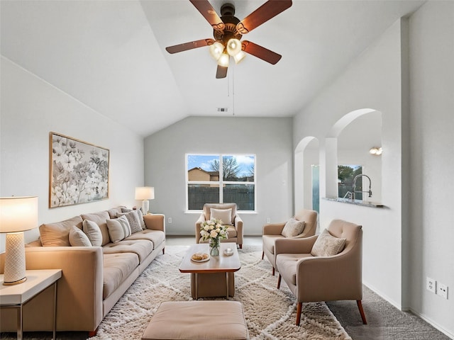 living room with vaulted ceiling, ceiling fan, and carpet floors