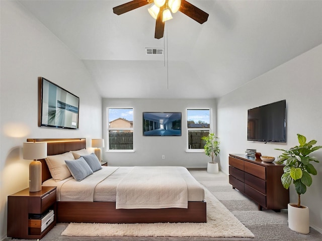 carpeted bedroom featuring ceiling fan and vaulted ceiling