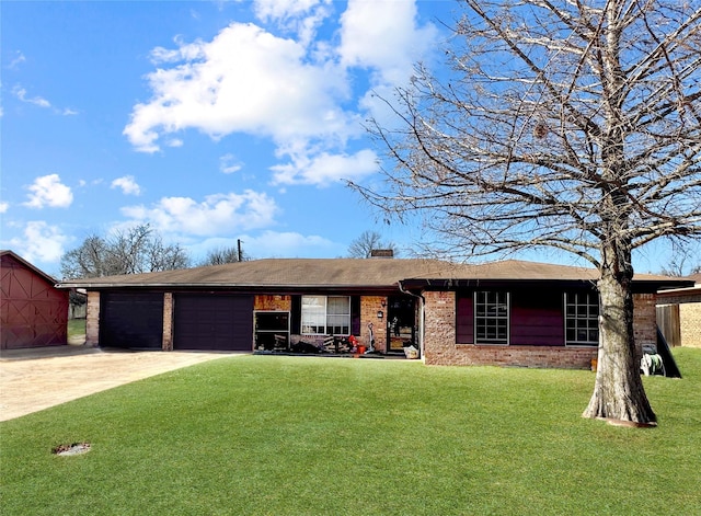 single story home featuring a chimney, concrete driveway, brick siding, an attached garage, and a front yard