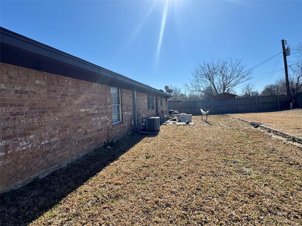 view of yard with central AC