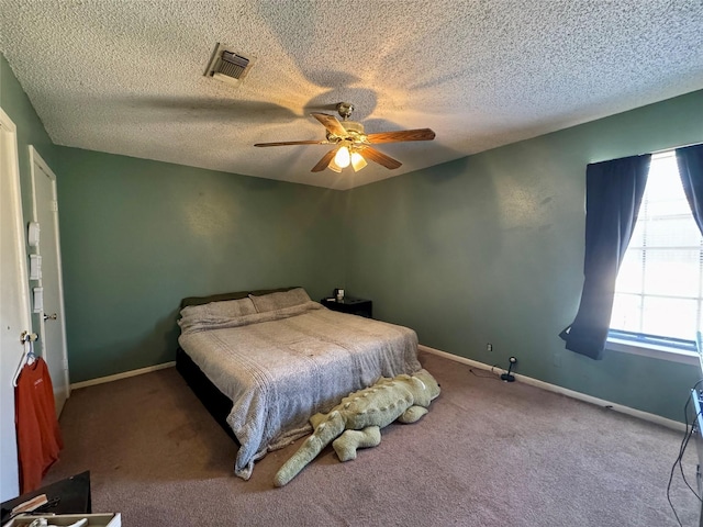 bedroom featuring carpet, visible vents, a textured ceiling, and ceiling fan