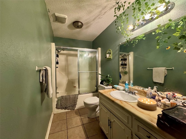 full bathroom with tile patterned floors, a textured ceiling, vanity, bath / shower combo with glass door, and baseboards