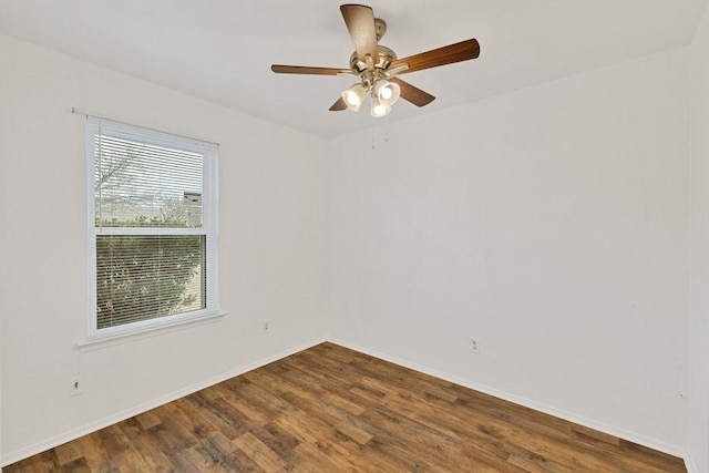 empty room with ceiling fan, baseboards, and wood finished floors