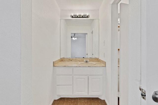 bathroom with vanity, baseboards, and tile patterned floors