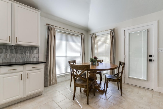 dining space with vaulted ceiling