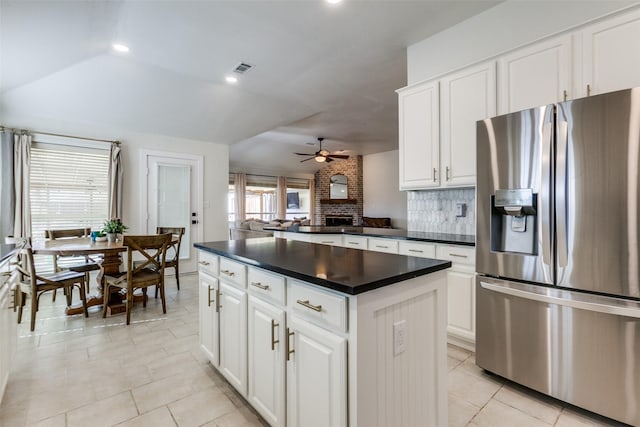 kitchen featuring white cabinets, a kitchen island, stainless steel fridge, and ceiling fan