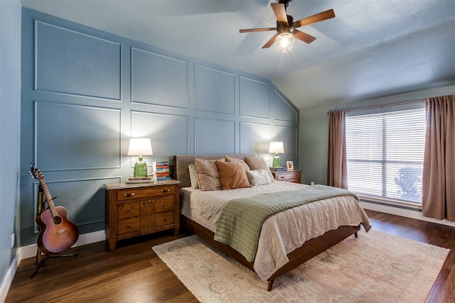 bedroom featuring lofted ceiling, dark wood-type flooring, and ceiling fan