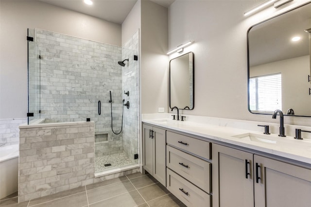 bathroom with shower with separate bathtub, vanity, and tile patterned floors