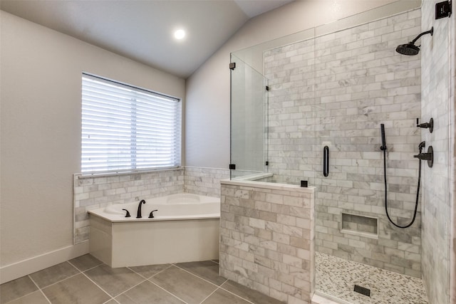 bathroom with tile patterned flooring, vaulted ceiling, and independent shower and bath