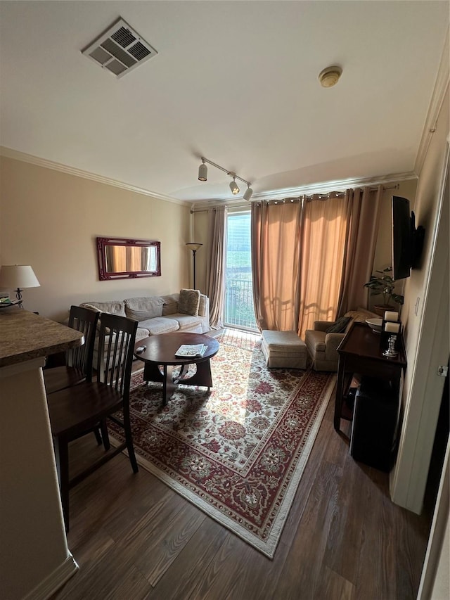 living room with crown molding, track lighting, and dark hardwood / wood-style floors