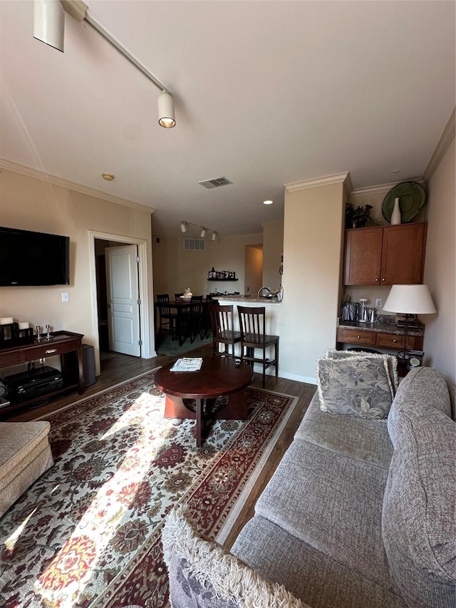 living room with dark hardwood / wood-style flooring and crown molding