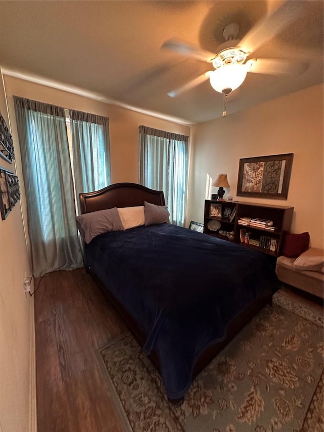 bedroom with hardwood / wood-style flooring and ceiling fan