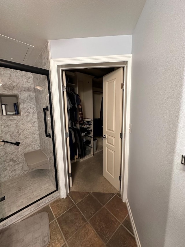 bathroom with tile patterned flooring and an enclosed shower