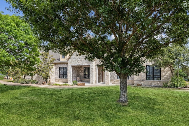 871 Beechwood Ln, Fairview, TX 75069 - view of property hidden behind natural elements featuring a front yard and stone siding