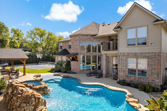 view of swimming pool featuring an in ground hot tub, a gazebo, tennis court, and a patio