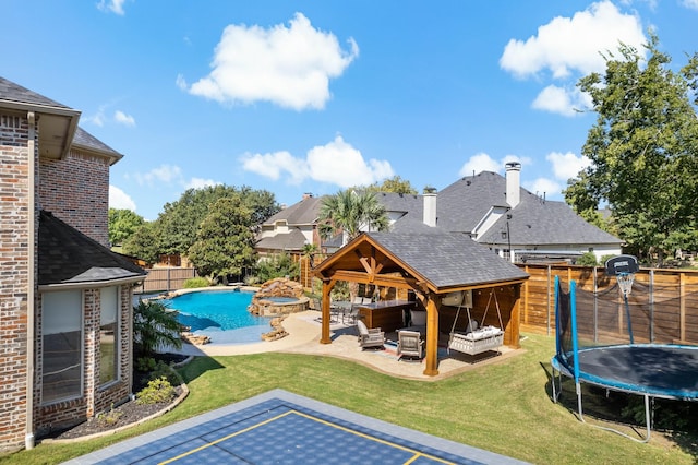 view of swimming pool with an outdoor living space, a yard, a patio area, and a trampoline