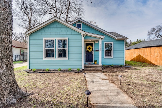 bungalow-style house with a front lawn