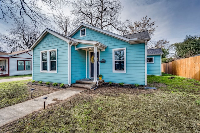 bungalow-style house featuring a front yard