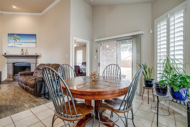 dining space with light tile patterned flooring and crown molding