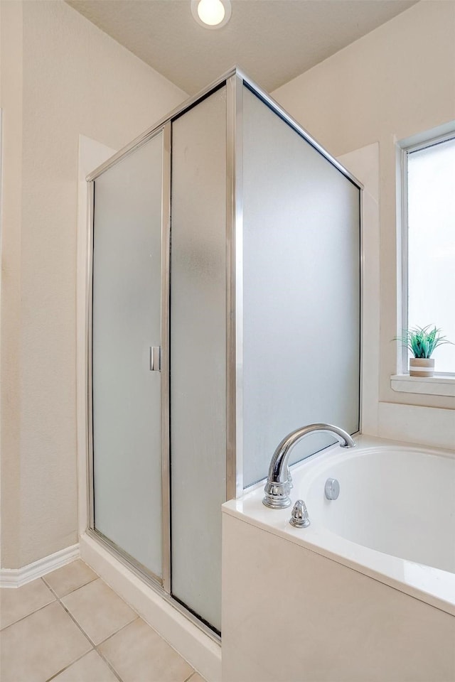 bathroom featuring tile patterned flooring and plus walk in shower