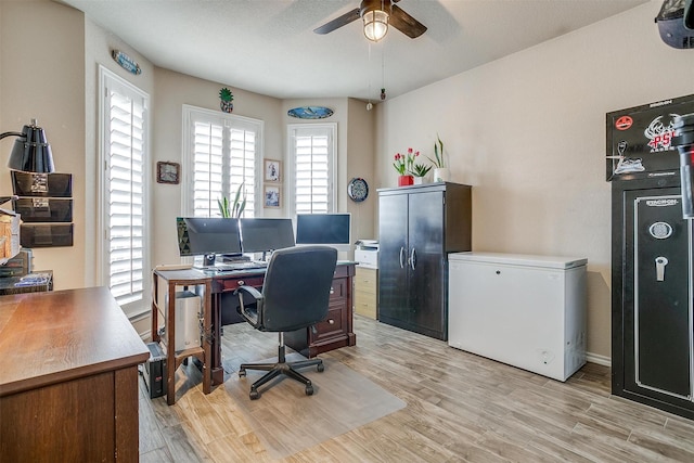 home office featuring ceiling fan and light hardwood / wood-style floors