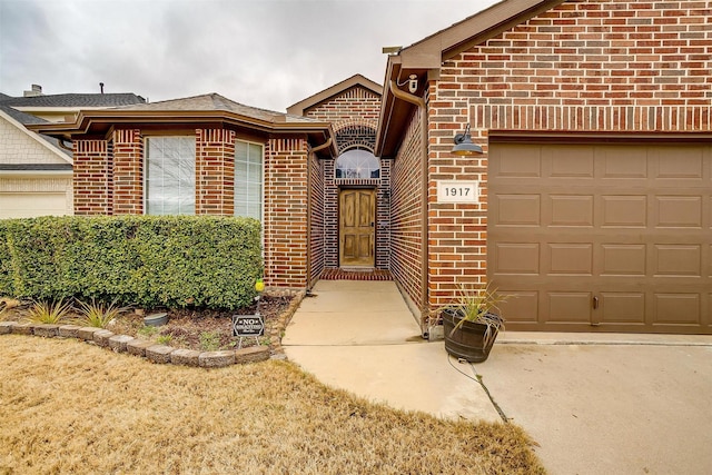 doorway to property with a garage