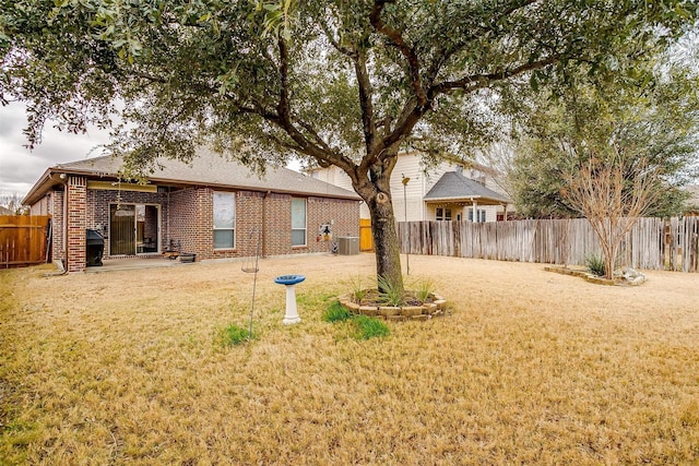 view of yard featuring a patio and central air condition unit